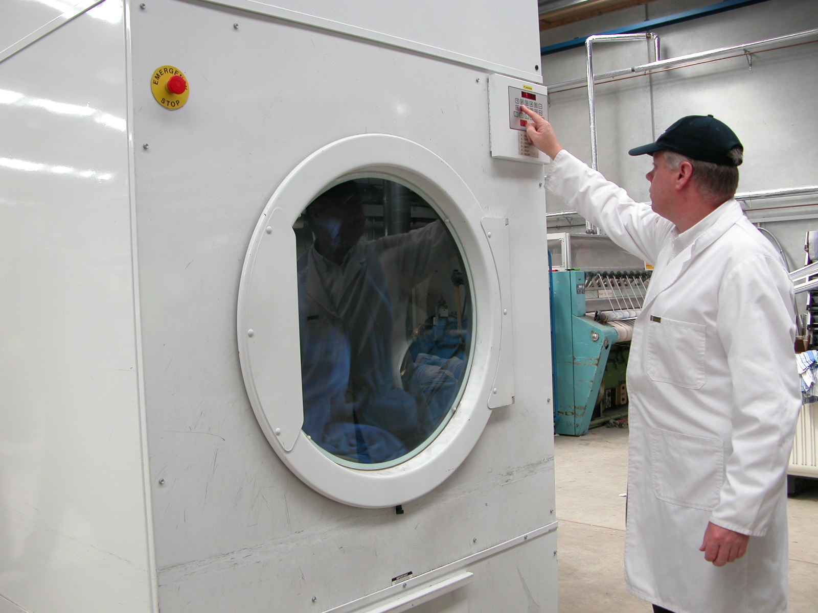 man operating big Laundry machine 